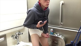 Handsome young stud caught masturbating in public bathroom